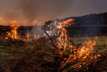 young guy crying in fire in burnt clothes, war, home destruction, human disappointment