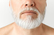 © master1305 - Cropped close-up image of grey-haired man's beard. Taking care after hair and beard. Mature male model against grey background. Concept of male beauty, face and skin care, daily procedures, age