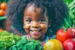 © Pictures Paradise - Happy little African American black girl with fruits.Portrait of a happy greengrocer standing in front of the vegetables.Grocery. Copy space text.