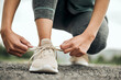 © Oostendorp/peopleimages.com - Shoes, run and a sports woman tying laces outdoor during a fitness workout for endurance or cardio. Exercise, health and training with a female athlete fastening footwear getting ready for running