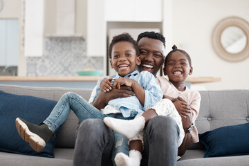 Canvas Print - Hug, happy and portrait of a father with children on the sofa for playing, bonding and laughing. Smile, black family and an African dad hugging kids with affection on a home couch for happiness