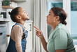 Conflict, mom talking and frustrated girl in kitchen, home or conversation about trouble, mistake or problem. Mother, angry kid and discussion of discipline, behaviour or speaking together in house