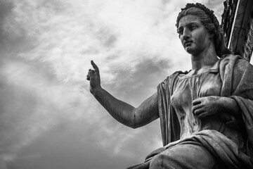 Poster - Grayscale of a female statue against a cloudy sky