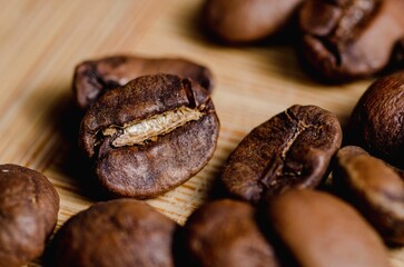 Poster - Beautiful closeup of coffee beans on wooden background