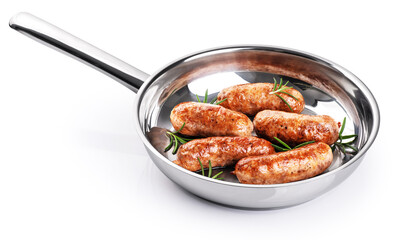 Wall Mural - Sausages with rosemary fried in a stainless steel pan isolated on white background. With clipping path.