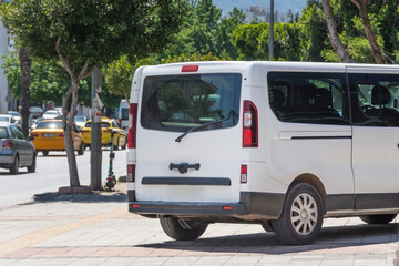 View of the back of the minibus, the door. Parking on a busy city street.