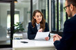 © bnenin - A businesswoman reading a cv of an ambitious man during the interview.