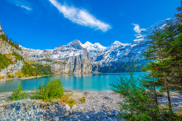 Wall Mural - Amazing tourquise Oeschinnensee with waterfalls and Swiss Alps, Kandersteg, Berner Oberland, Switzerland.