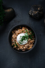 Poster - Boiled buckwheat porridge with fried onions, poached egg and herbs.