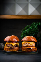 Poster - American beef and chicken burgers with cheddar cheese, pickled cucumbers, tomatoes and ketchup.