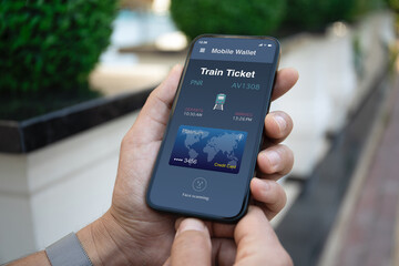 Male hand hold phone with train ticket application on screen