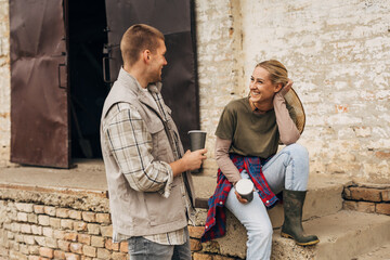 A man and a woman in love talking to each other outside.