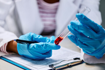 Close up of African American female scientist working on research in laboratory.