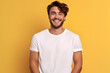Young man wearing bella canvas white shirt mockup, at yellow background. Design tshirt template, print presentation mock-up. AI generated.