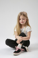 Wall Mural - Studio portrait of beautiful little girl in black and white outfit white background