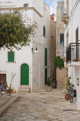 Wall Mural - picturesque Polignano a Mare square corner with bicycles, Puglia, Italy