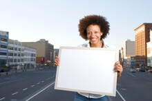 African American Woman With Blank Board On City Street In Summer