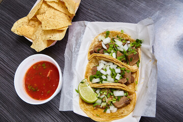 Meal 3 corn tortilla lengua cow beef tongue street tacos Mexican with chips red salsa