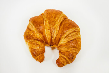 Top down view of fresh baked crescent shaped croissant on white background