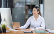 © David - Asian Business woman using calculator and laptop for doing math finance on an office desk, tax, report, accounting, statistics, and analytical research concept