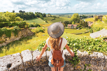 Wall Mural - Rear view of woman looking at green vineyard in Bordeaux region, Saint Emilion- France, Nouvelle aquitaine