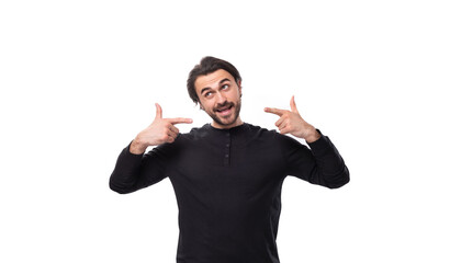 young confused handsome brunet european man in black sweatshirt on isolated white background