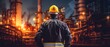 Worker stands and observes an oil refinery in a protective jacket and helmet. Security concept. Generative AI