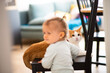 cat play with toddler girl, focused on cat face, authentic home interior