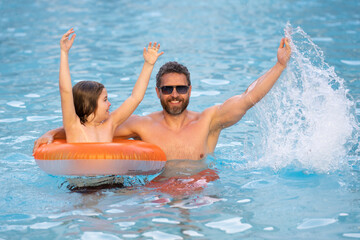 Wall Mural - Father and son swimming in pool, summer family weekeng. Father and son on summer family holiday. Father and son relaxing in pool water. Family in swimming pool. Child with dad swimming in pool.