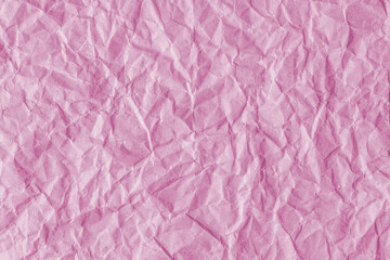 Recycled crumpled pink paper texture background. Wrinkled and creased abstract backdrop, wallpaper with copy space, top view.