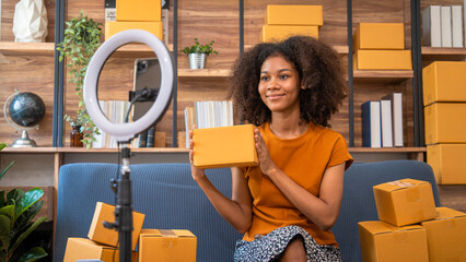 Wall Mural - African American business woman working at warehouse preparing SME package box for delivery at small business home office.