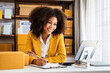 © Phushutter - African American business woman working at warehouse preparing SME package box for delivery at small business home office.