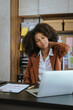 © Phushutter - Tired african american business woman working with audit, balance sheet, investing activities, safety stock, net loss, business risks, accumulated depreciation, factory overhead, accrued expense