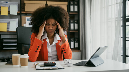 Tired african american business woman working with audit, balance sheet, investing activities, safety stock, net loss, business risks, accumulated depreciation, factory overhead, accrued expense