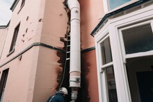 Downpipe Being Replaced On Old Building, With The New Pipe Clearly Visible, Created With Generative Ai