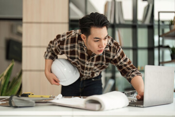 Canvas Print - Engineer working in office with blueprints. Engineer inspect architectural plan, sketching a construction project