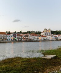 Poster - Beautiful landscape over the riverside area of Alcacer do Sal, Portugal with buildings on the shore