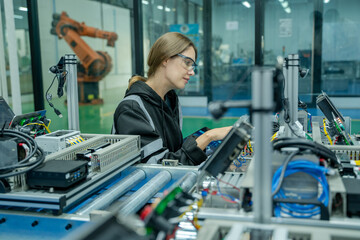 Leinwandbilder - Robotics industry concept,Robotics control engineers setting and maintain spare parts of industrial robot arm controller in production plant factory.