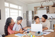© Alexis Scholtz/peopleimages.com - Elearning, laptop and parents with their kids in the dining room of their family house. Technology, home school and children students working on online homework with their mother and father at home.