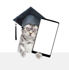 Aufkleber - Сollege graduate kitten holds big smartphone with white blank screen in it paw, showing close to camera. isolated on white background