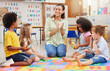 © N Lawrenson/peopleimages.com - Diversity, teacher with children at school and in a classroom with a lens flare. Education or learning, happiness and smile with female person with kindergarten kids playing together in a class