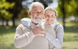 Old couple hug in park with love and smile in portrait, retirement together with trust and support with care. Elderly man, woman and marriage with commitment, relationship and happy people outdoor
