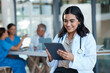 © N Lawrenson/peopleimages.com - Hospital, doctor and Indian woman on tablet for medical analysis, research and report in meeting. Healthcare, clinic and female nurse on digital tech for wellness app, online consulting and service