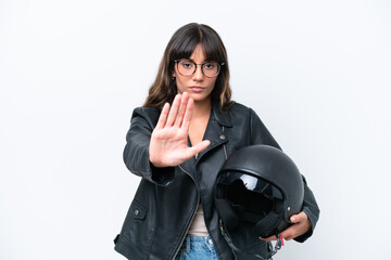 Wall Mural - Young caucasian woman with a motorcycle helmet isolated on white background making stop gesture