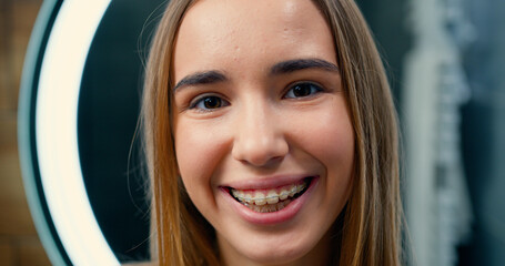 Portrait face of young woman with beautiful dark eyes look and smile into camera. Female, beauty, confident, happy, cheerful, close up