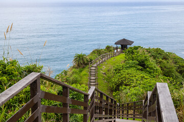 Poster - Wooden step hiking trail over the mountain with the sea view