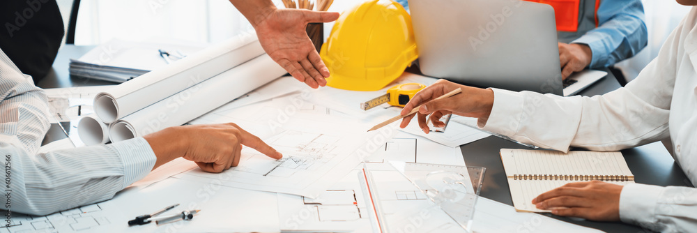 Engineer partner drawing and working on blueprint design together on ...