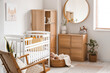 © Pixel-Shot - Interior of light bedroom with baby crib, drawers and mirror