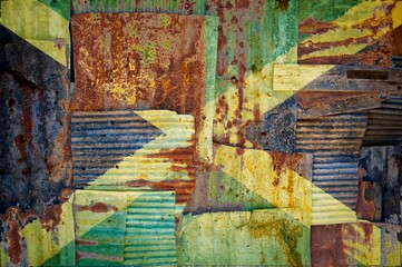 Sticker - Flag of Jamaica on rusty corrugated iron sheets forming a wall or a fence