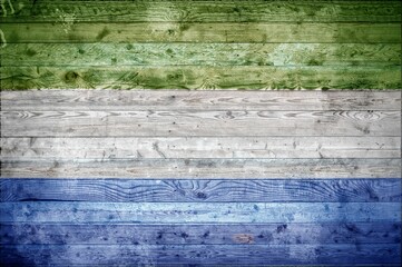 Wall Mural - Vignetted background image of the flag of Sierra Leone onto wooden boards of a wall or floor